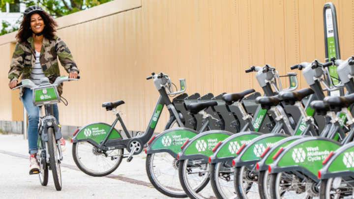 Woman cycling on West Midlands Cycle hire bike. 